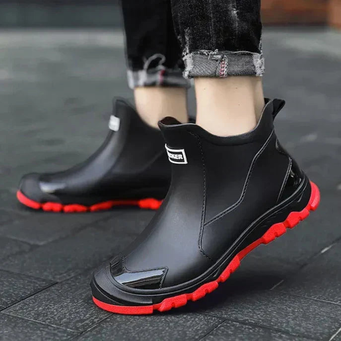 Ankle Chelsea boots with round toes, pull tabs and treaded flat soles