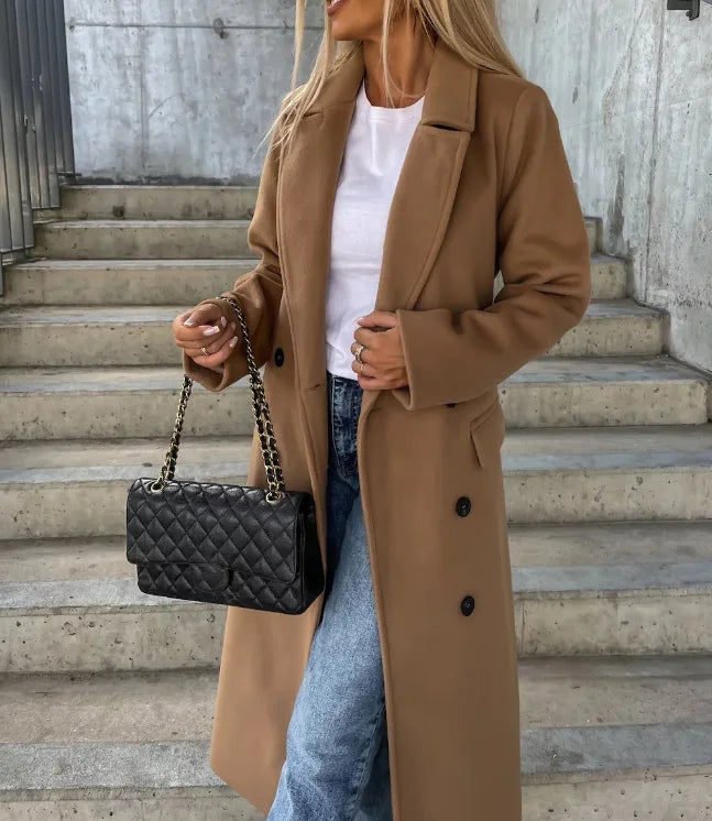 Women's long double-breasted structured coat with notched lapels, tie belt and flap pockets