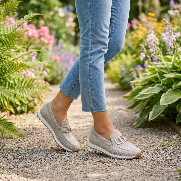 Women's textured slip-on sneakers with metallic buckle detail and flat ridged soles