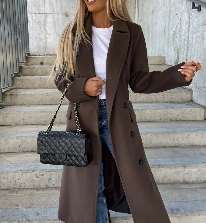 Women's long double-breasted structured coat with notched lapels, tie belt and flap pockets