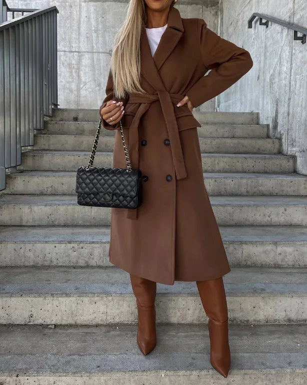Women's long double-breasted structured coat with notched lapels, tie belt and flap pockets