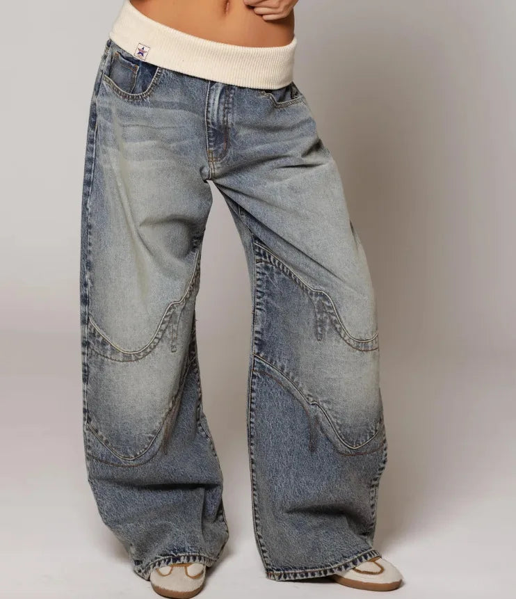 Women's light blue baggy wide leg jeans with ribbed waistband and curved panel detailing