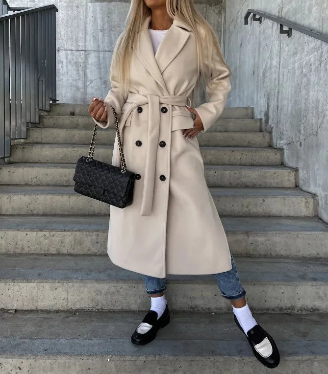 Women's long double-breasted structured coat with notched lapels, tie belt and flap pockets