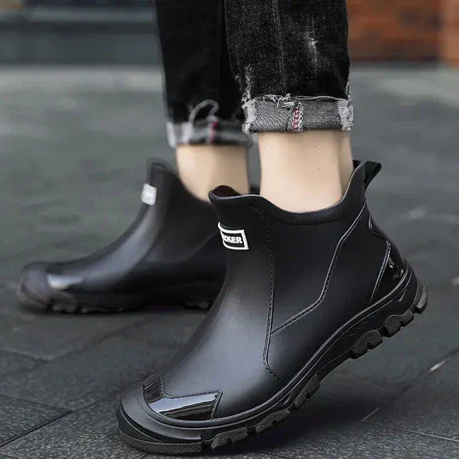 Ankle Chelsea boots with round toes, pull tabs and treaded flat soles