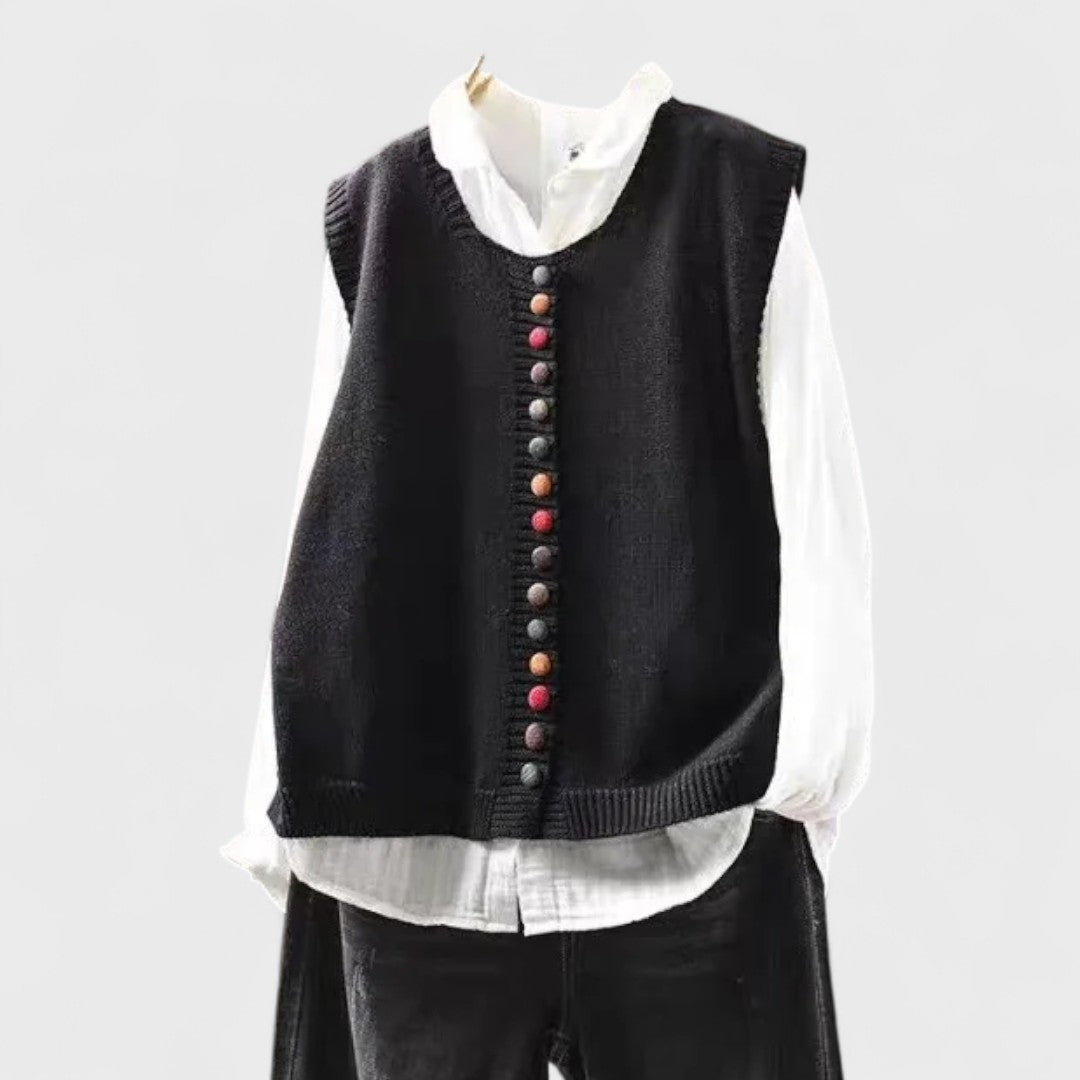 Sleeveless V-neck button front cardigan vest layered over a white collared blouse
