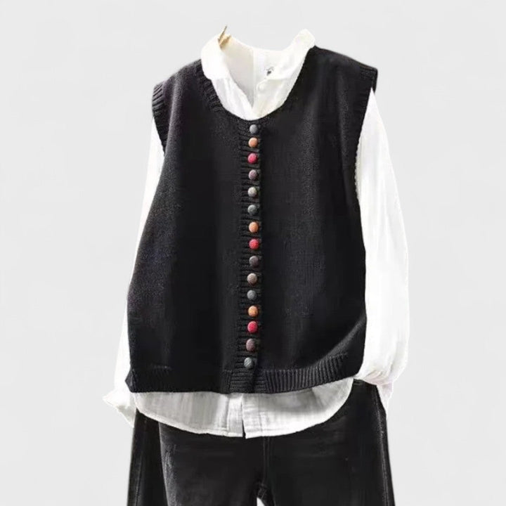 Sleeveless V-neck button front cardigan vest layered over a white collared blouse
