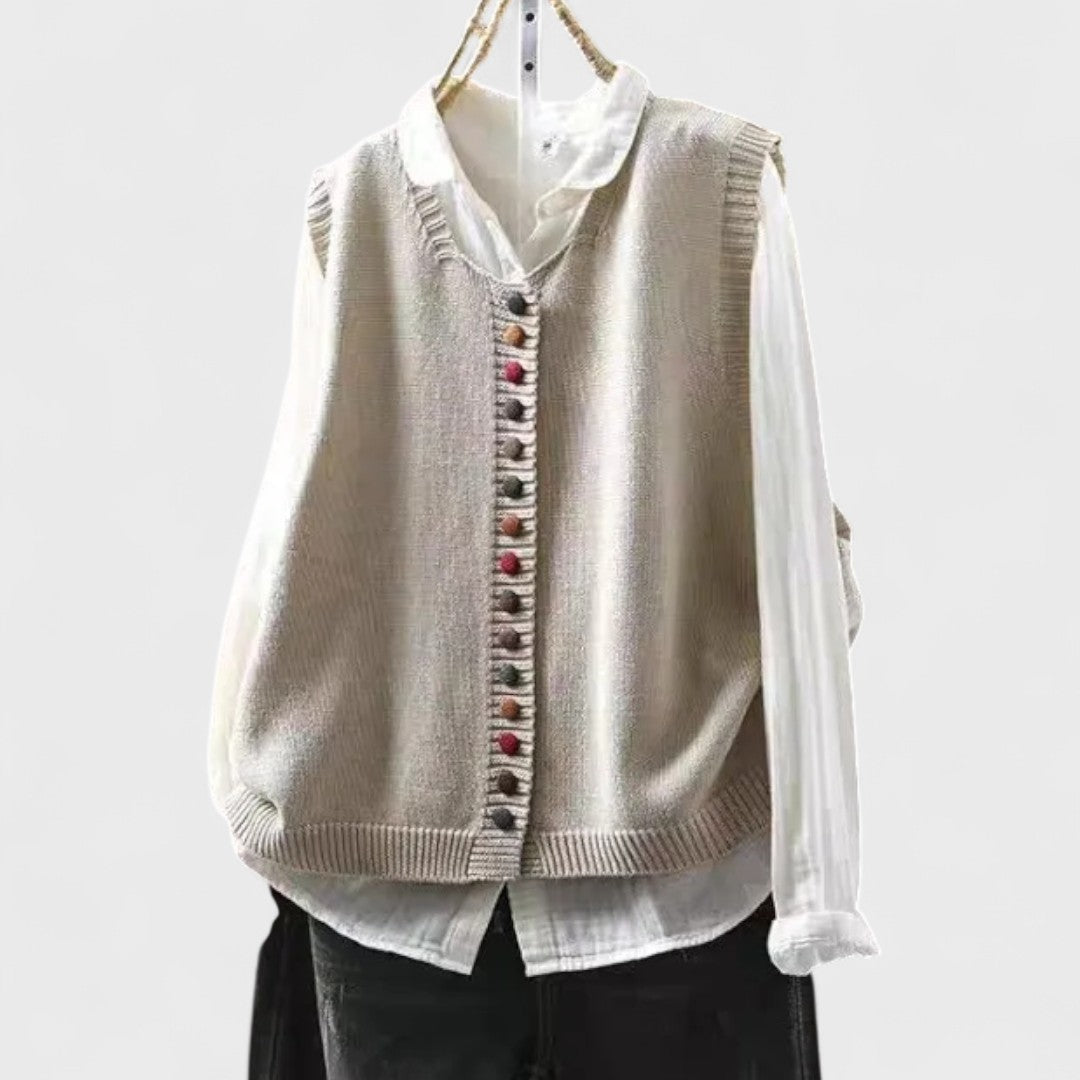 Sleeveless V-neck button front cardigan vest layered over a white collared blouse