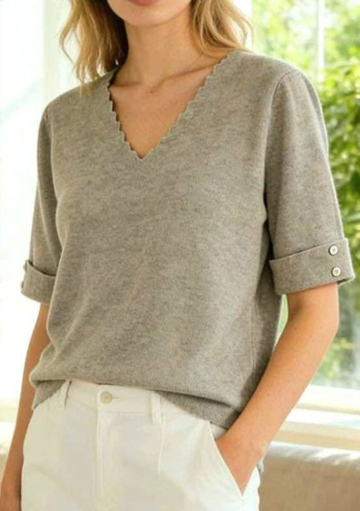 Women's black fine-knit top with scalloped V-neck and cuffed short sleeves