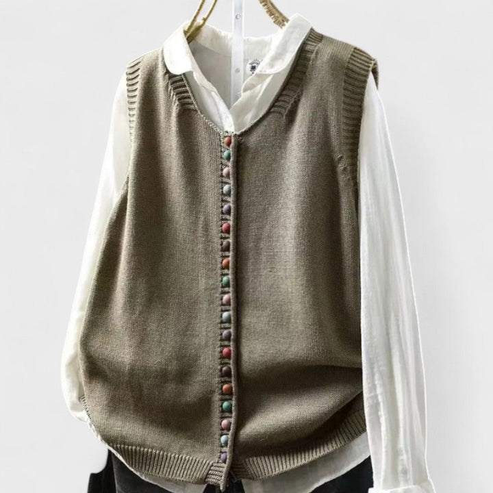 Sleeveless V-neck button front cardigan vest layered over a white collared blouse