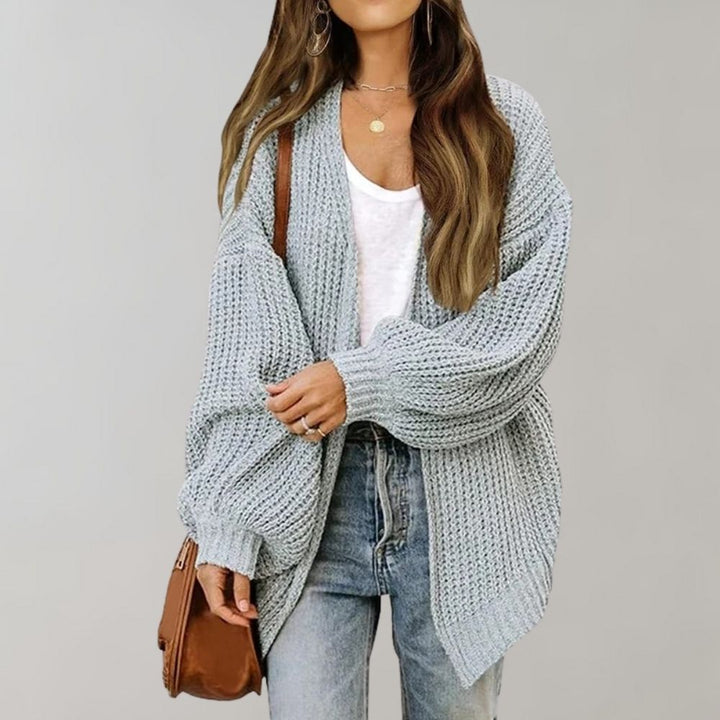 Women's open front textured knit cardigan with long sleeves and curved hem
