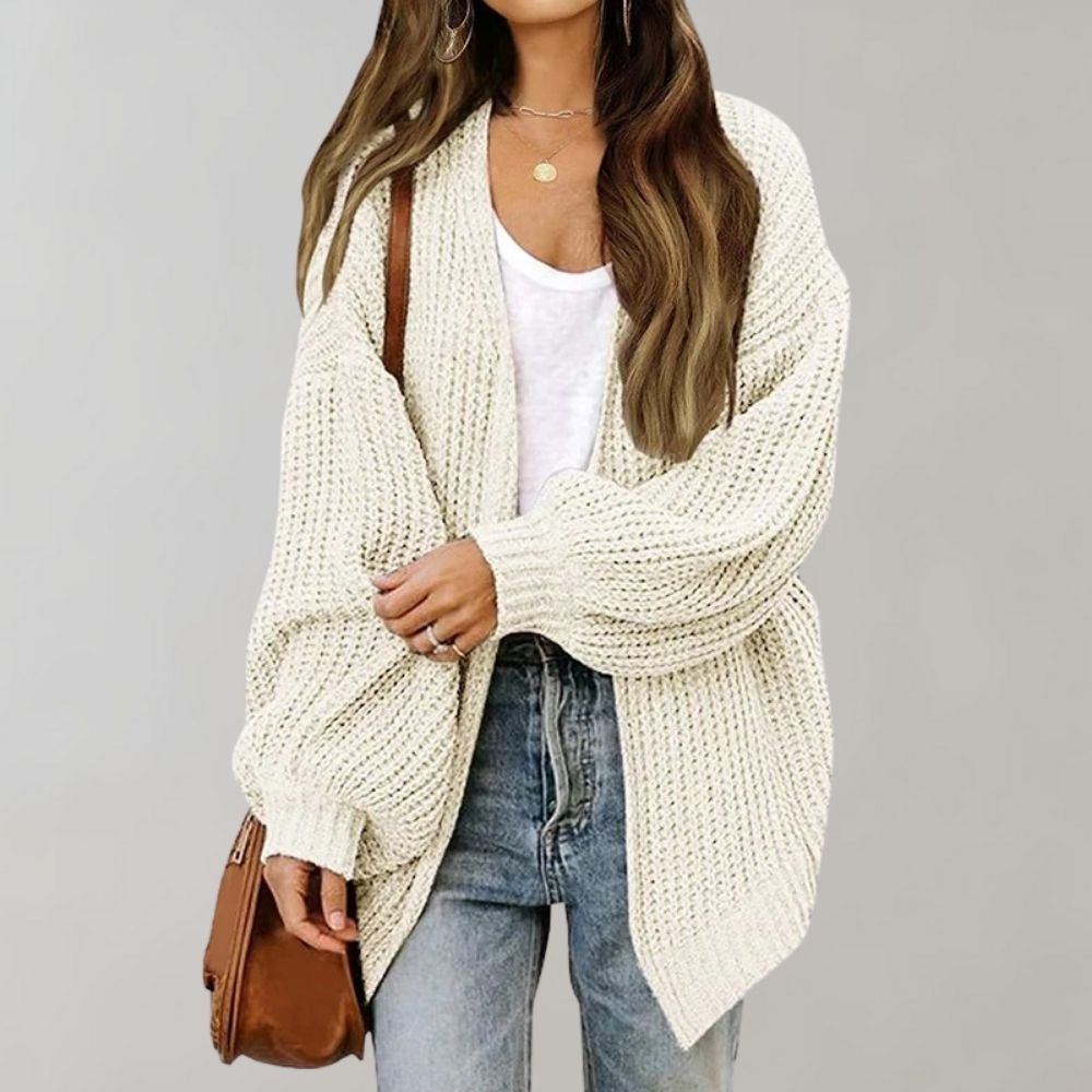 Women's open front textured knit cardigan with long sleeves and curved hem