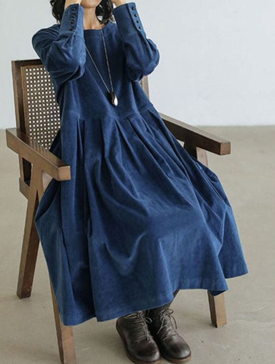 Women's long-sleeve pleated maxi dress with a round neckline and full skirt