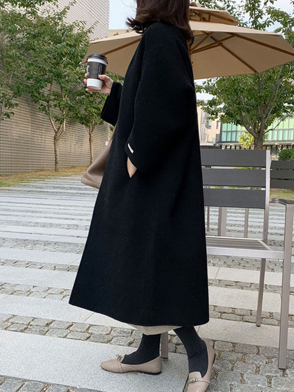 Women's collarless longline coat with open front and wide sleeves