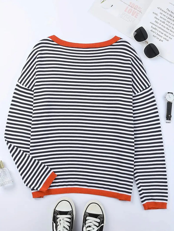 Women's black and white striped jumper with orange ribbed trims