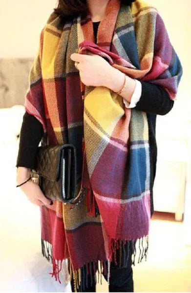 Women's checked fringe scarf worn as a draped shoulder wrap