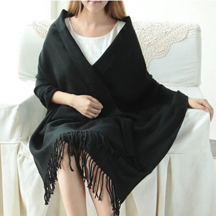 Women's checked fringe scarf worn as a draped shoulder wrap