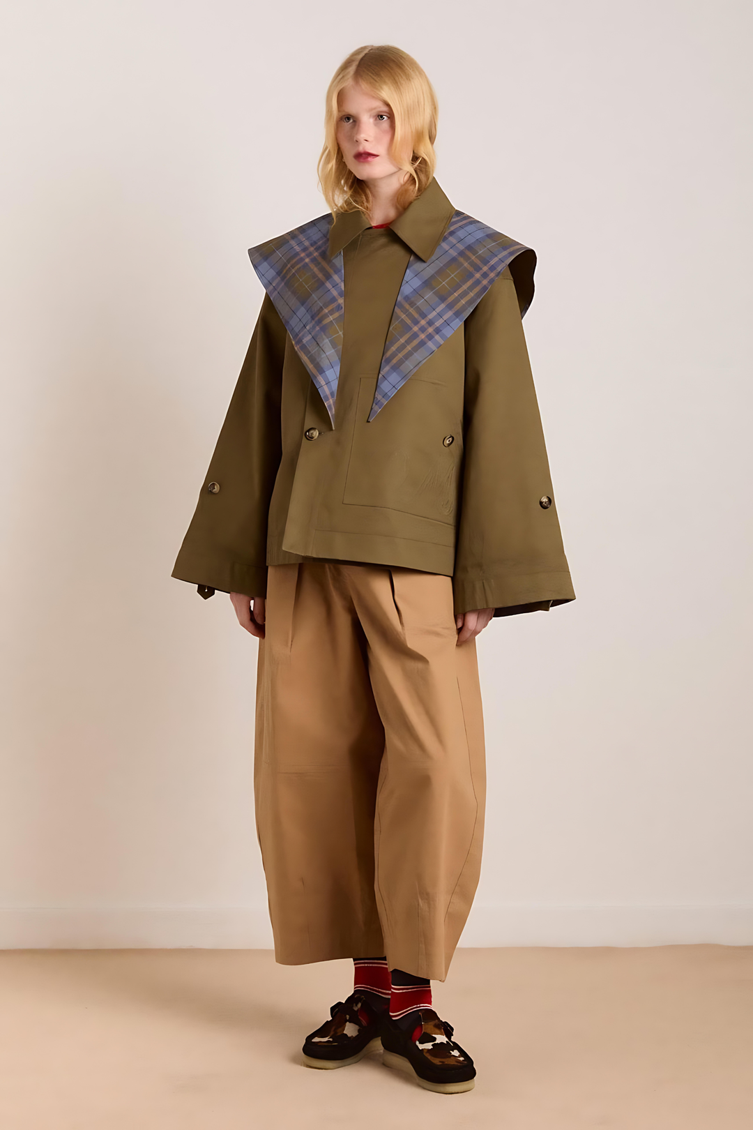 Women's brown jacket with blue plaid trim, raised collar and button front