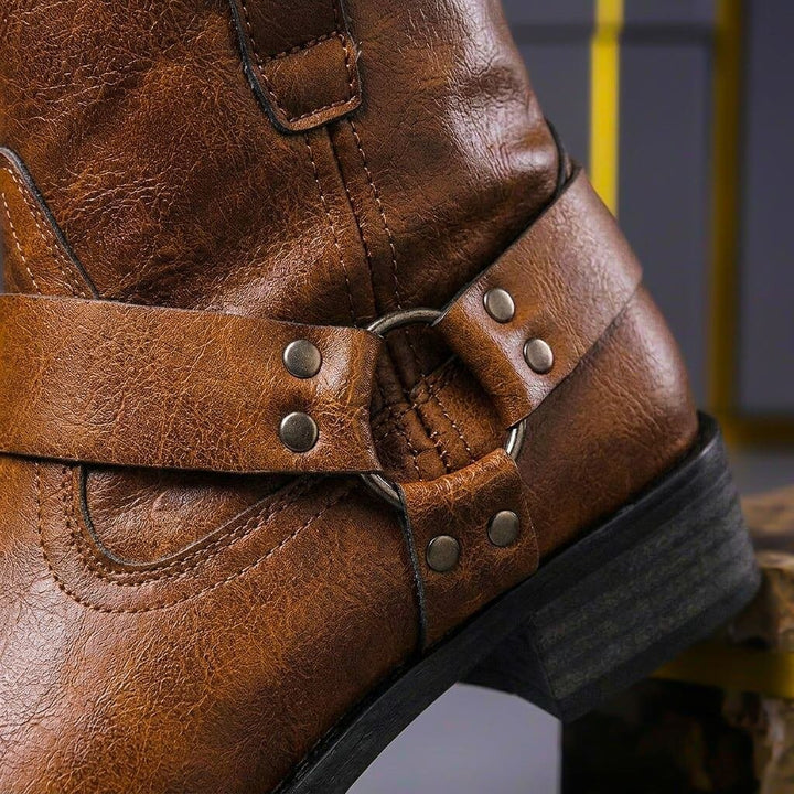 Women's brown and black biker ankle boots with buckle straps and low heels