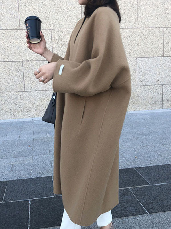 Women's collarless longline coat with open front and wide sleeves