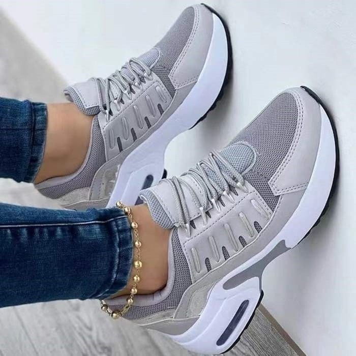 Women's low-top lace-up sneakers with layered panels and chunky sculpted soles