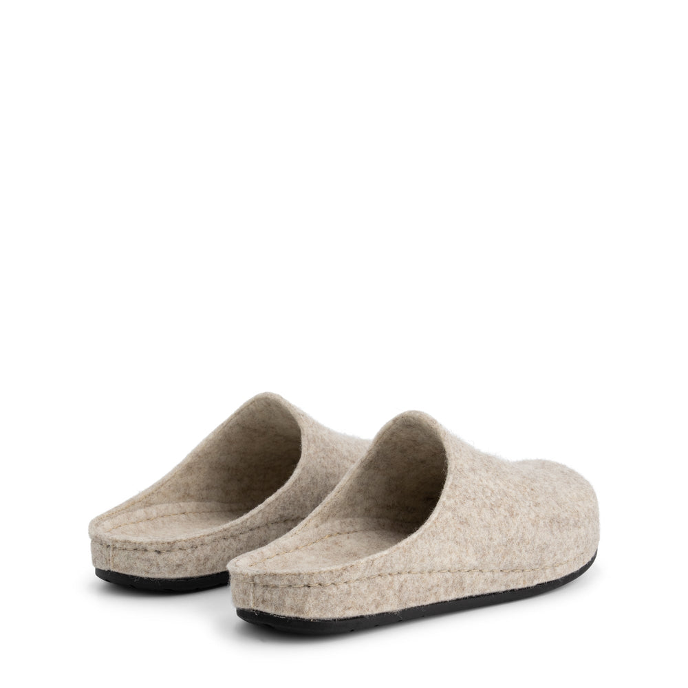 Beige closed-toe slip-on house slippers with black flat soles