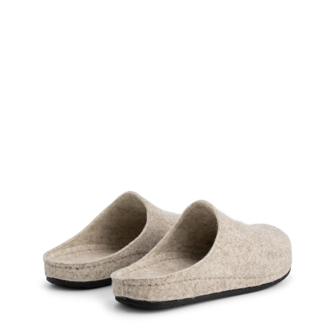 Beige closed-toe slip-on house slippers with black flat soles