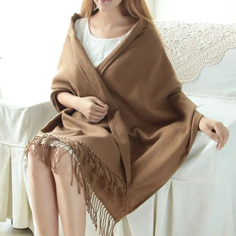 Women's checked fringe scarf worn as a draped shoulder wrap