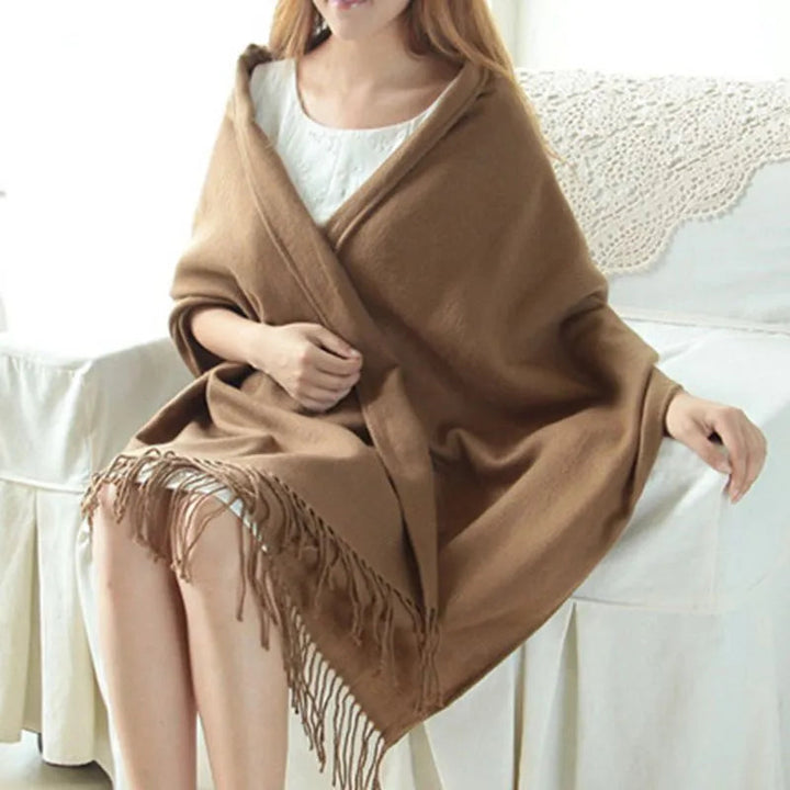Women's checked fringe scarf worn as a draped shoulder wrap