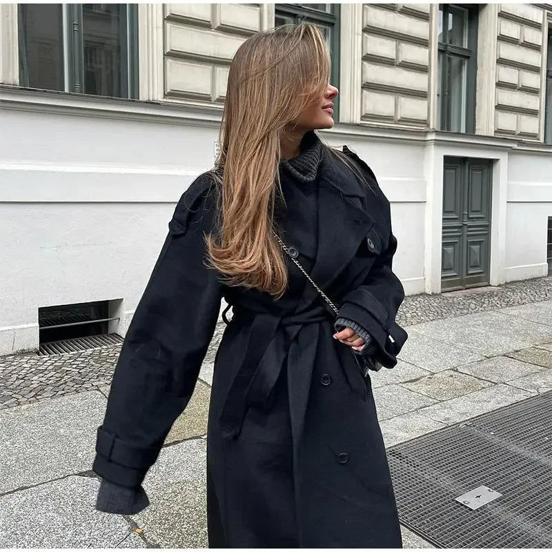 Women's black long double-breasted trench coat with lapels and waist belt