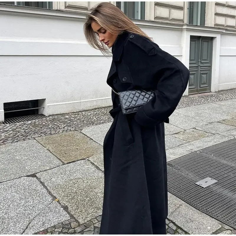 Women's black long double-breasted trench coat with lapels and waist belt