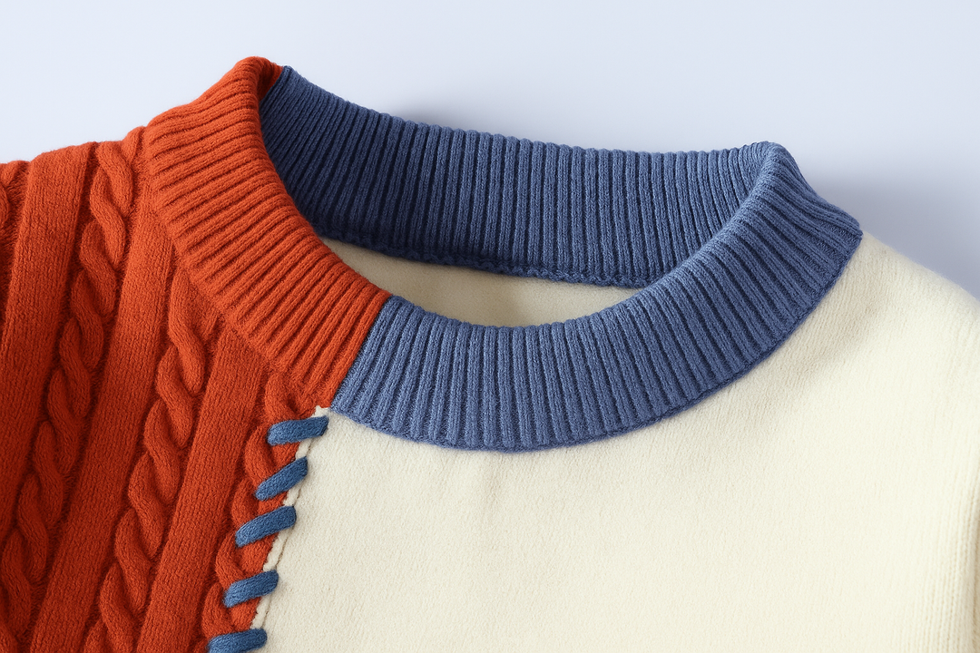 Women's patchwork cable knit sweater with crew neck and contrasting stitched panels