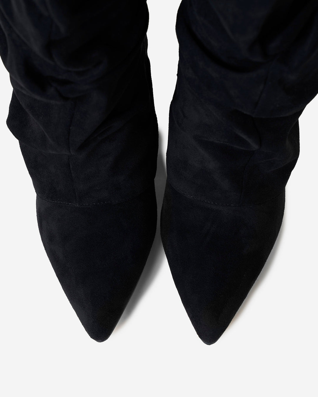 Black women's slouchy knee-high boots with pointed toes and buckle straps