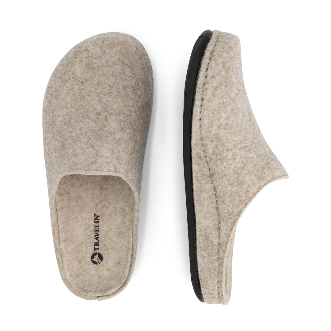 Beige closed-toe slip-on house slippers with black flat soles