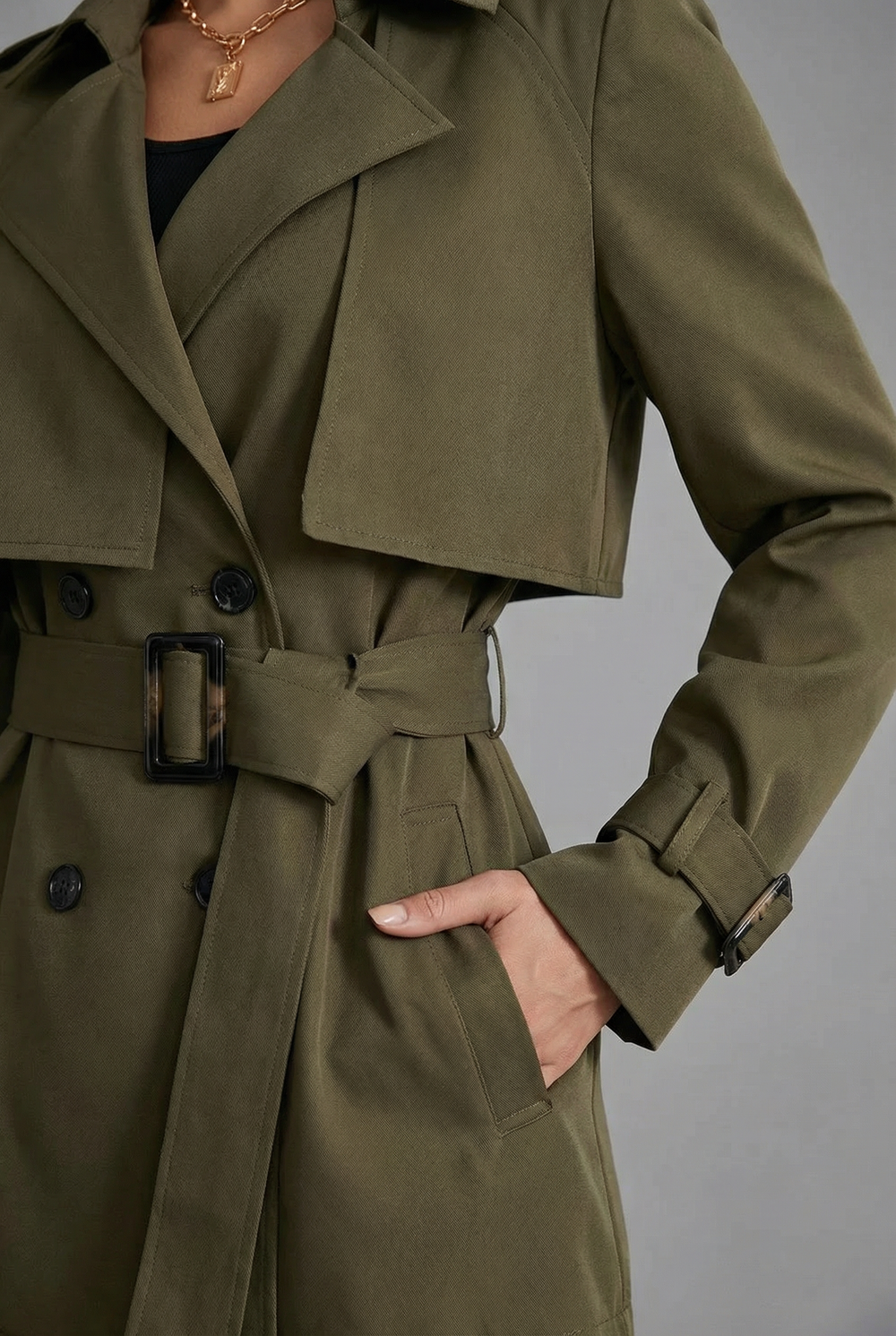 Women's green belted trench coat with notched lapels and long sleeves