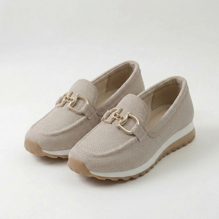 Women's textured slip-on sneakers with metallic buckle detail and flat ridged soles