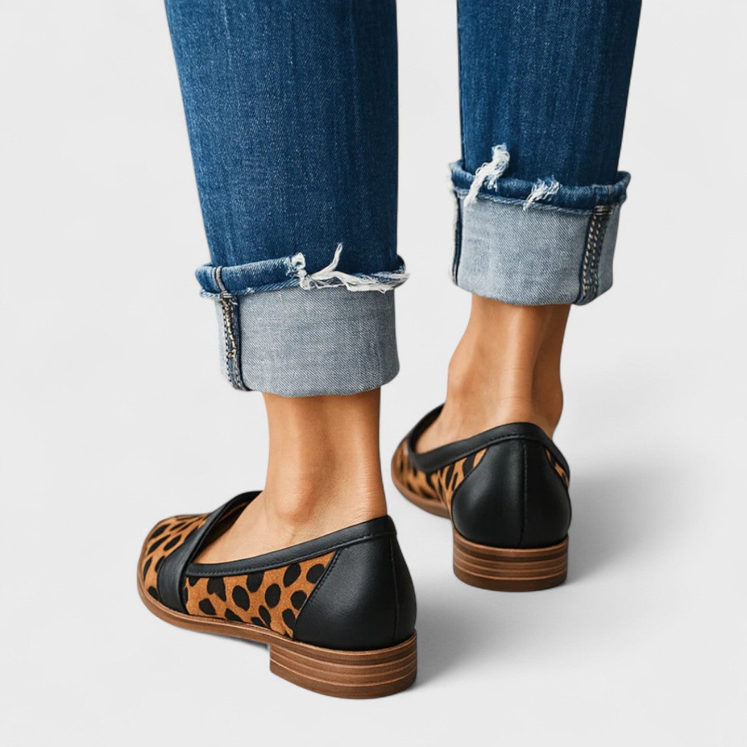 Women's pointed-toe penny loafers with low heels and front strap detail
