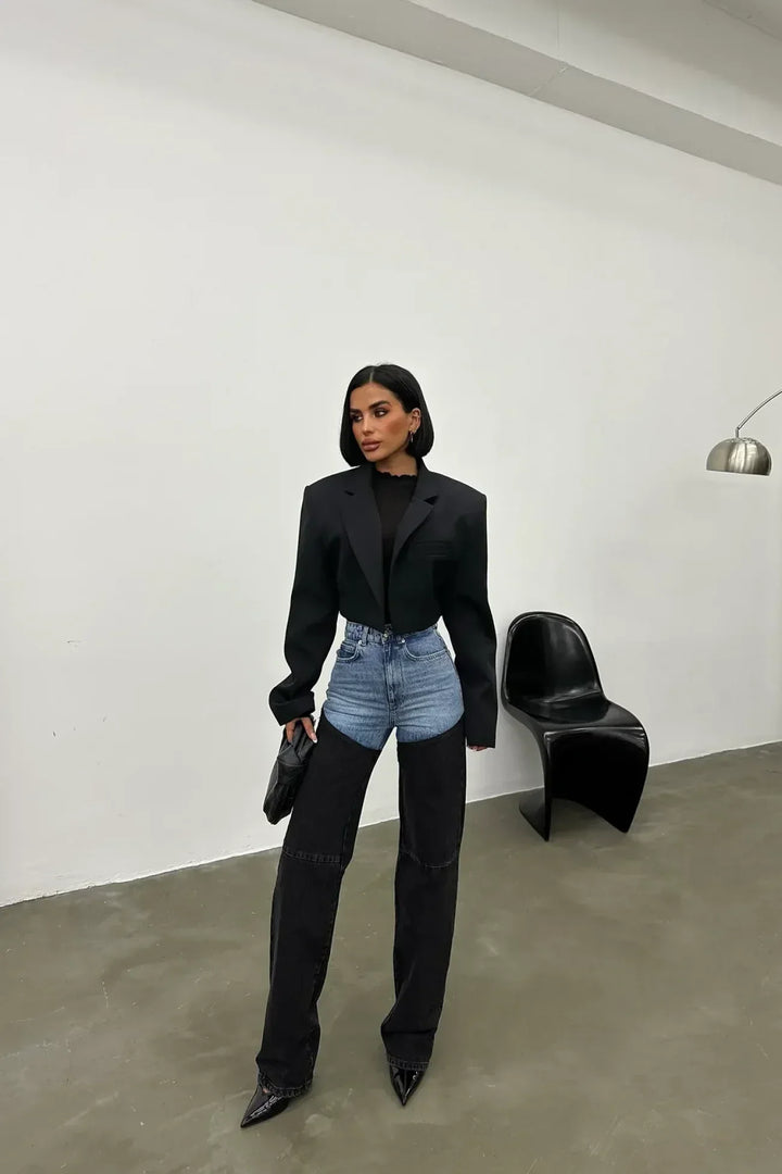 Women's high-waisted two-tone jeans with light blue upper panels and black straight legs