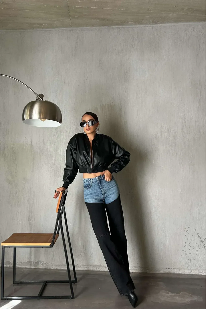 Women's high-waisted two-tone jeans with light blue upper panels and black straight legs