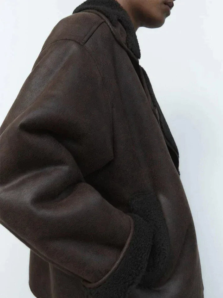 Women's brown oversized aviator jacket with wide dark collar and cuffs