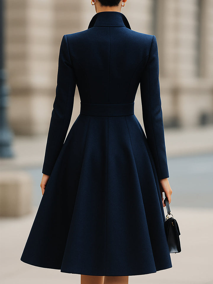 Women's navy tailored midi dress with peak lapel collar, long sleeves and flared skirt