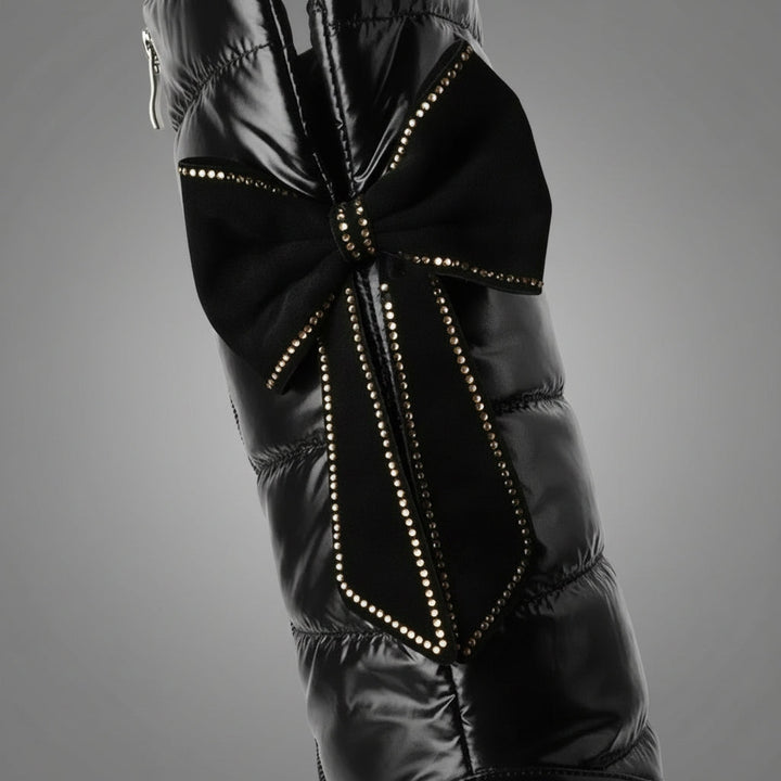 Women's black quilted over-the-knee boots with round toes, flat platform soles and bow detail