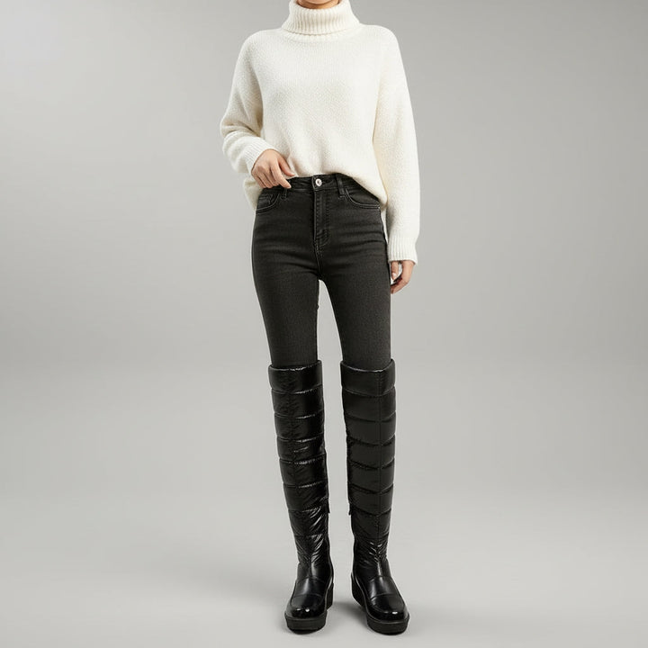 Women's black quilted over-the-knee boots with round toes, flat platform soles and bow detail