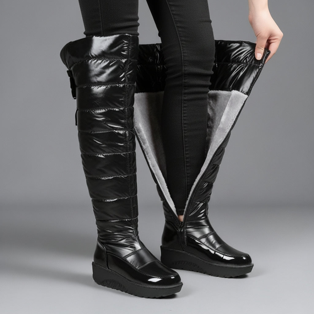 Women's black quilted over-the-knee boots with round toes, flat platform soles and bow detail