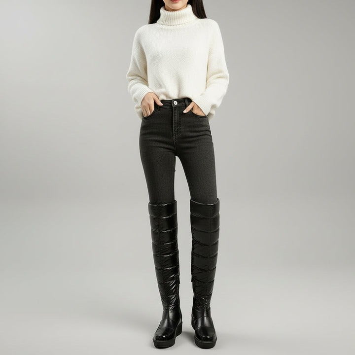 Women's black quilted over-the-knee boots with round toes, flat platform soles and bow detail