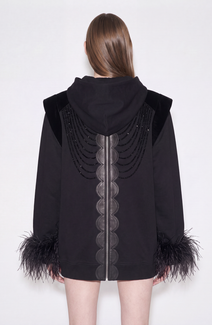 Black hooded zip hoodie with embellished front and feather-trimmed cuffs