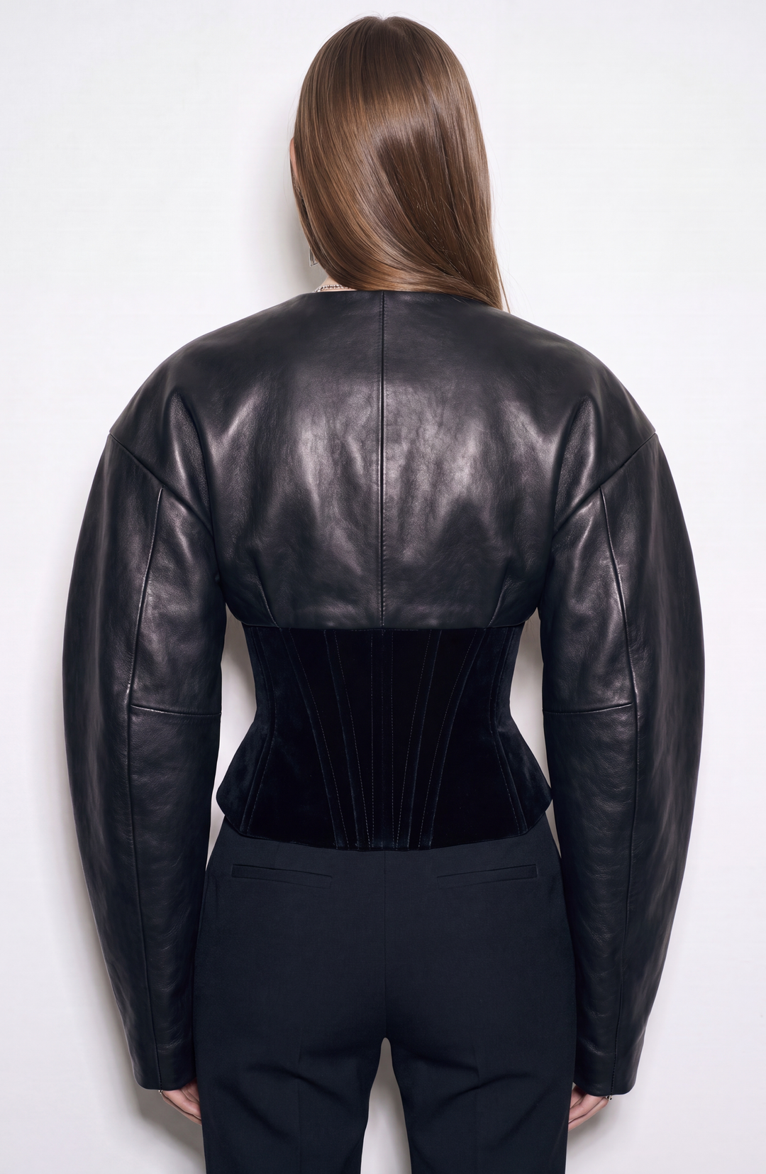 Black women's corset jacket with glossy upper panels, long sleeves and a front zipper
