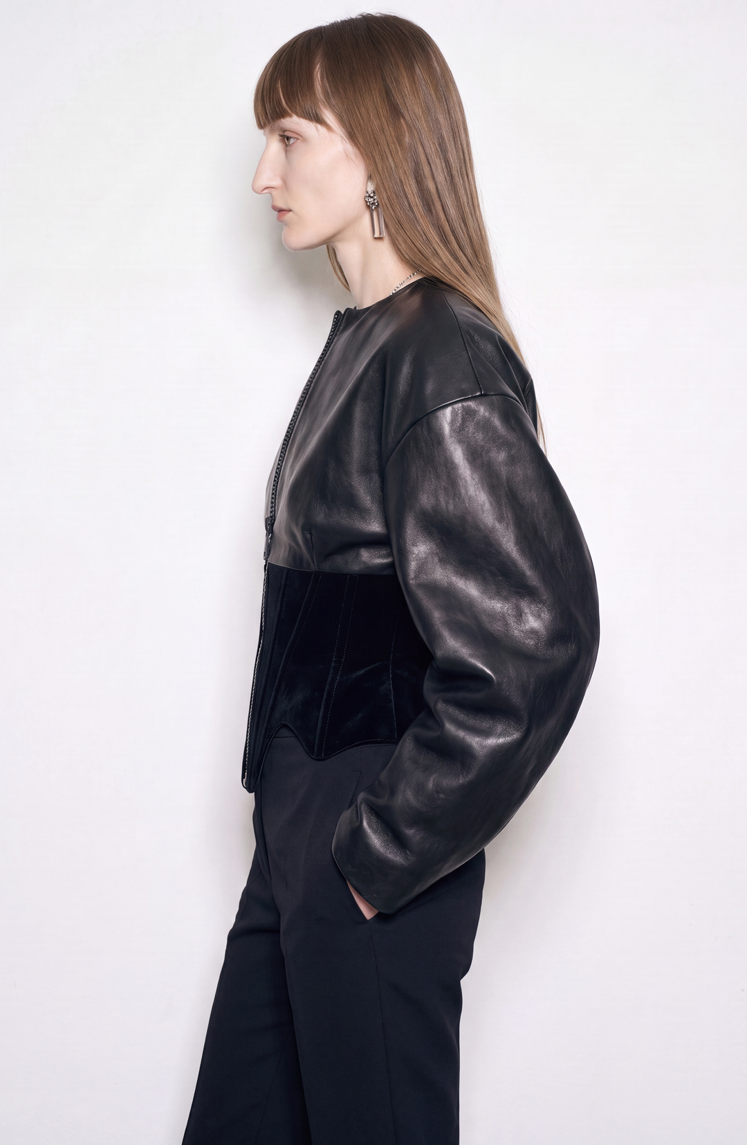 Black women's corset jacket with glossy upper panels, long sleeves and a front zipper