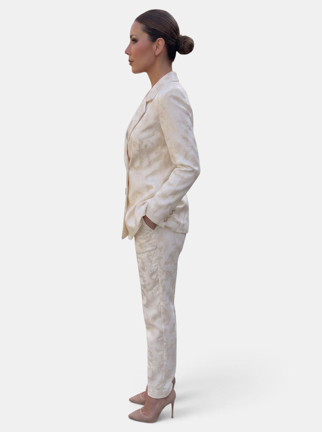 Woman wearing a patterned blazer and wide leg trousers suit