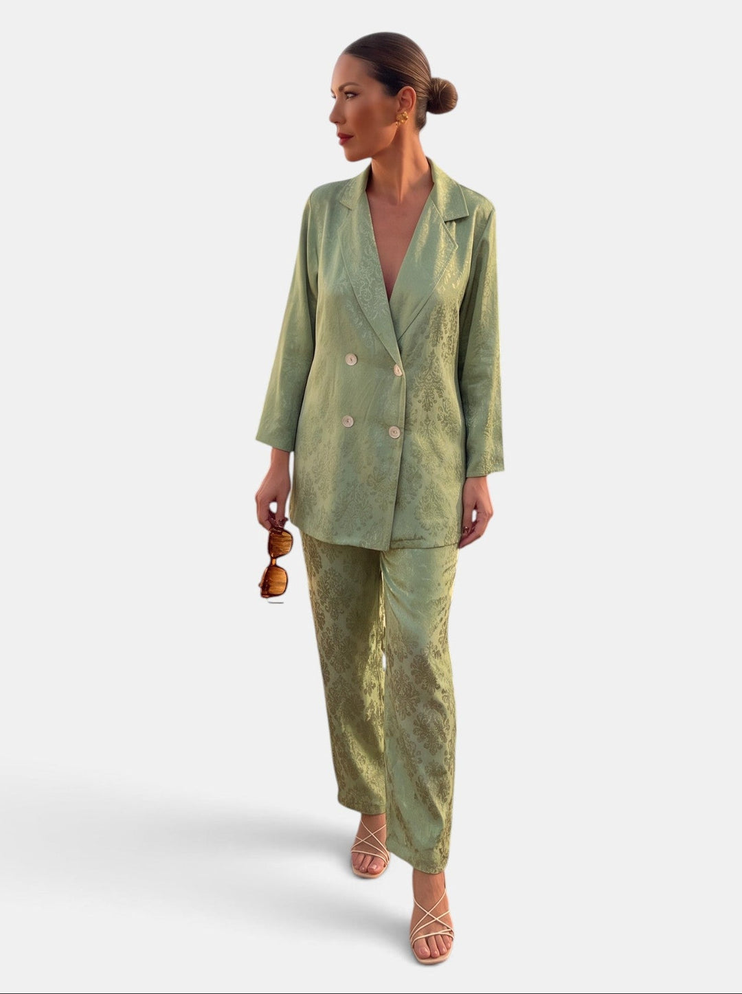 Woman wearing a patterned blazer and wide leg trousers suit