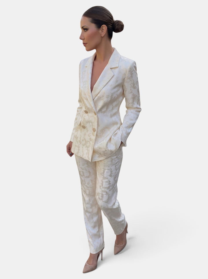 Woman wearing a patterned blazer and wide leg trousers suit